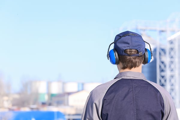 Construction worker protecting hearing